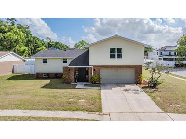 Charming two-story home features a brick facade, attached garage, and well-manicured lawn at 206 Soldier Ct, Seffner, FL 33584