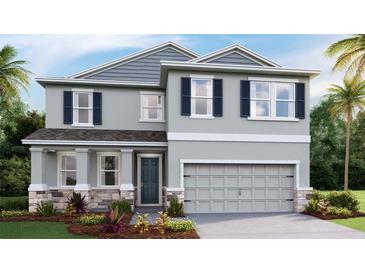 Two-story home with gray siding, dark shutters, stone accents, and a two-car garage at 3316 Amber Waves Dr, Plant City, FL 33565