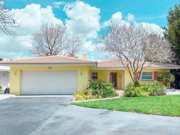 Charming single-story home featuring a two-car garage and well-maintained landscaping in a sunny neighborhood at 175 Bath Club N Blvd, North Redington Beach, FL 33708