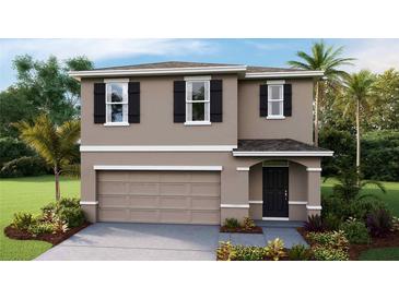 Charming two-story home featuring a symmetrical facade, neutral color palette, and well-maintained landscaping at 36130 Sunflower Hill Dr, Zephyrhills, FL 33541