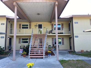 Charming two-story condo with covered entryway, adorned with flowers and outdoor seating at 4518 Narraganset Trl # 85A, Sarasota, FL 34233
