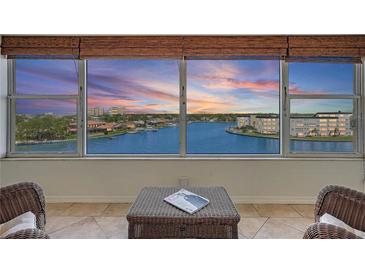 Breathtaking water view from the condo with a picturesque sunset and comfortable seating area at 6075 Shore S Blvd # 509, Gulfport, FL 33707