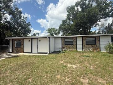 View of the home's exterior with stone accents, offering style and curb appeal at 1204 E Camellia Dr, Brandon, FL 33510