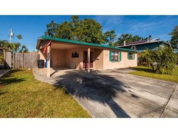 Tan single story home, long driveway and covered porch at 4126 Carson Ne St, St Petersburg, FL 33703