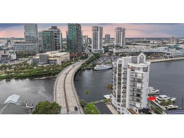 Stunning aerial view of waterfront condos with private docks and cityscape backdrop at 600 Garrison Cove Ln # 2B, Tampa, FL 33602