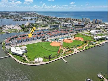 Aerial view of waterfront condos, ROC Park, baseball fields, and beach in Madeira Beach, Florida at 337 Rex Pl # E, Madeira Beach, FL 33708