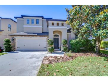 Charming two-story home with a two-car garage, manicured lawn and beautiful landscaping at 2515 Cross More St, Valrico, FL 33594