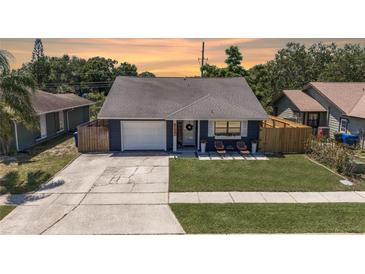 Charming home with a well-manicured lawn, welcoming front porch, and an attached single car garage at 3106 Whispering S Dr, Largo, FL 33771