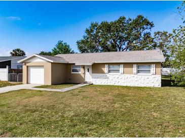 Charming single-story home featuring a blend of stucco and stone facade plus an attached single car garage at 428 Flamingo Dr, Apollo Beach, FL 33572