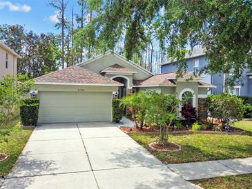 Charming single Gathering home featuring a 2 car garage and beautiful landscaping at 21840 Waverly Shores Ln, Land O Lakes, FL 34637