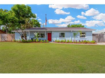 Charming single-story home boasts a lush lawn and cheerful red front door at 1008 Greenbriar Dr, Brandon, FL 33511