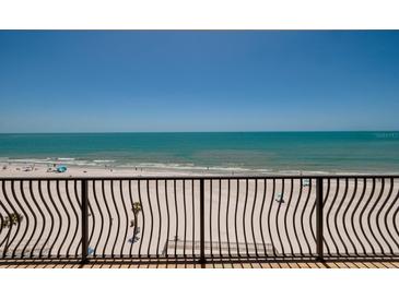 Beautiful beach view from balcony with railings on a clear day at 13600 Gulf Blvd # 700A, St Petersburg, FL 33708