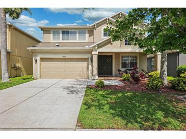 Charming two-story home with a well-maintained lawn and attached two car garage at 2800 Flagler Ct, Trinity, FL 34655