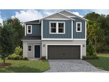 Two-story home featuring blue siding, a gray stone foundation, and a two-car garage at 37244 Sagemoor Dr, Zephyrhills, FL 33541