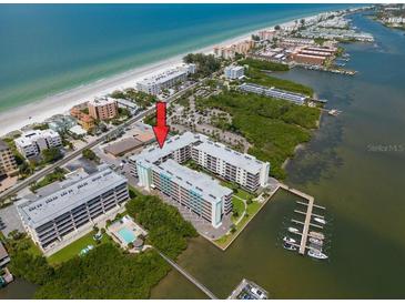 Stunning aerial view of a beachfront condo complex with a marina and gulf views at 19531 Gulf Blvd # 210, Indian Shores, FL 33785