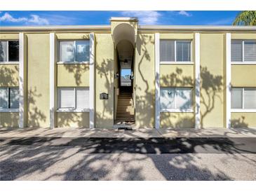 Inviting condo complex with stucco facade, trimmed windows and stairs leading to the upper units at 3206 W Azeele St # 126, Tampa, FL 33609