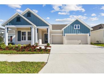 Charming single-Gathering home boasting a two-car garage and beautifully landscaped front yard at 5979 Hidden Branch Dr, Apollo Beach, FL 33572