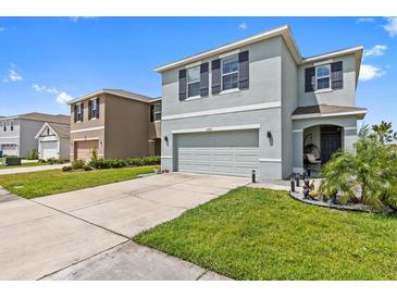 Charming two-story home exterior, featuring well-manicured lawn and desirable curb appeal in a vibrant neighborhood at 10937 Penny Gale Loop, San Antonio, FL 33576
