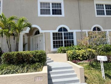 Charming home featuring white trim windows, a well-manicured yard, and a welcoming entrance at 232 Columbia Dr, Tampa, FL 33606