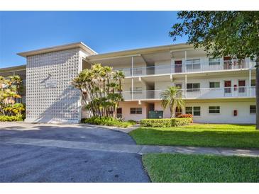 Well-maintained building featuring a classic design, mature trees, and neatly manicured landscaping at 5155 9Th N Ave # 102, St Petersburg, FL 33710