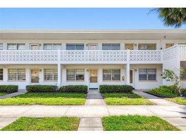 Well-maintained condo exterior with neat landscaping and uniform architectural details at 1000 79Th N Ave # 211, St Petersburg, FL 33702