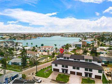 Stunning aerial view of property near waterfront featuring lush landscaping and community pool at 187 145Th E Ave # 4, St Petersburg, FL 33708