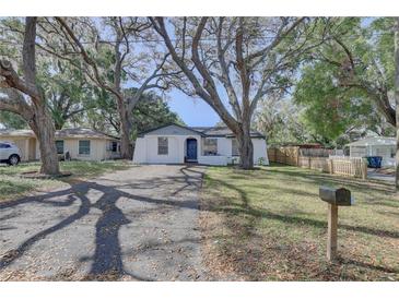 Charming single-story home with mature trees and a well-manicured front yard at 2009 E Eskimo Ave, Tampa, FL 33604