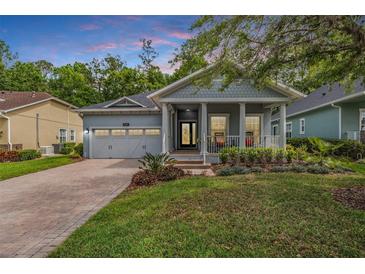 Charming single-Gathering home with brick driveway, manicured lawn, and inviting front porch at 19529 Lily Pond Ct, Brooksville, FL 34601