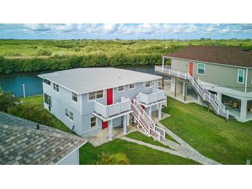 Two story duplex features an open balcony, large front yard, and waterway access at 8940 Rocky Creek Dr, Tampa, FL 33615