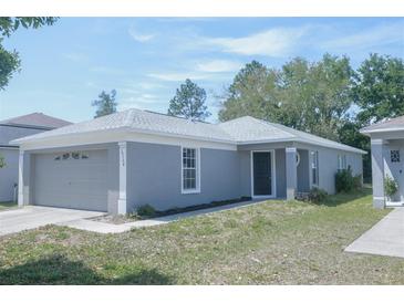 Charming single-story home with a well-maintained lawn and attached two-car garage at 10728 Navigation Dr, Riverview, FL 33579