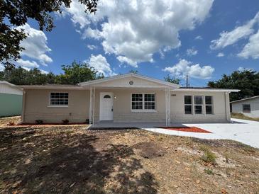 Attractive single-story home with well-manicured lawn and welcoming curb appeal at 12801 College Hill Dr, Hudson, FL 34667