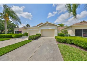 Inviting single-story home with a manicured lawn, mature trees, and a private two-car garage at 2220 Nantucket Dr # 43, Sun City Center, FL 33573