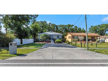 Charming single-story home featuring a long driveway, well-maintained lawn, and welcoming curb appeal at 403 Saint Petersburg W Dr, Oldsmar, FL 34677