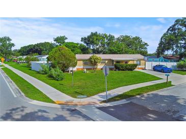 Charming single-story home featuring a well-manicured lawn and mature landscaping at 8210 68Th N Way, Pinellas Park, FL 33781