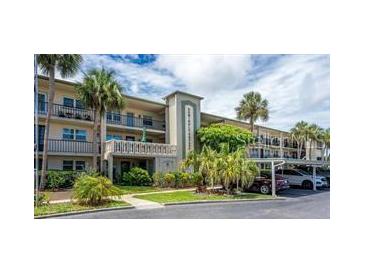 Well maintained multi-story building with mature tropical landscaping and convenient parking at 11720 Park Blvd # 301, Seminole, FL 33772