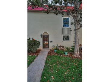 Charming exterior view of a townhome with a well-maintained lawn and landscaping at 2700 Bayshore Blvd # 547, Dunedin, FL 34698