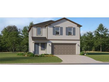 Charming two-story home featuring gray siding, a two-car garage, and manicured landscaping at 5607 Red Kite Dr, Wimauma, FL 33598