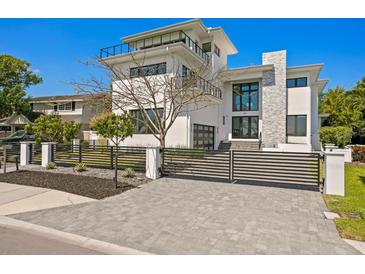 Modern two-story home with a gated driveway and black metal fence for added security at 804 S Davis Blvd, Tampa, FL 33606