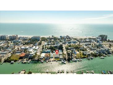 Aerial view of canal-front homes near a stunning beach, perfect for boating and coastal living at 12412 Lagoon Ln, Treasure Island, FL 33706