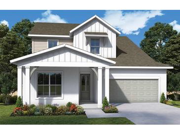 Charming two-story home with a well-manicured lawn and attached garage at 5269 Everlong Dr, Apollo Beach, FL 33572