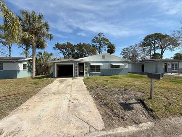 Charming single-story home featuring an attached garage and a well-maintained front yard at 6706 Del Prado Ter, New Port Richey, FL 34652