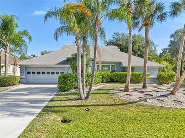Charming single story home with well-manicured lawn and mature landscaping at 26180 Deep Creek Blvd, Punta Gorda, FL 33983