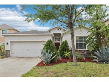 Charming single-story home with well-maintained landscaping and a two-car garage at 304 Shell Manor Dr, Ruskin, FL 33570