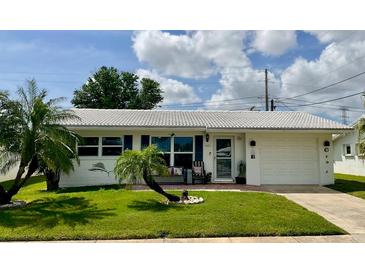 Charming single-story home with well-maintained lawn and a quaint front patio at 3890 Mainlands N Blvd, Pinellas Park, FL 33782