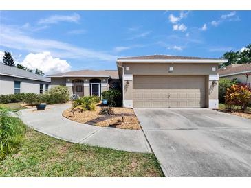 Charming single-story home featuring a two-car garage, neutral stucco, landscaped yard and inviting walkway to the front door at 4017 3Rd E Ave, Bradenton, FL 34208