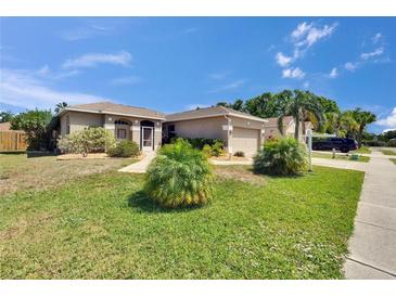 Well-manicured lawn, mature shrubbery, and palm trees enhance the curb appeal of this home at 4017 3Rd E Ave, Bradenton, FL 34208