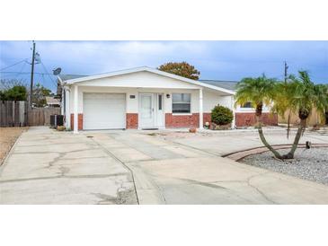 Charming single-story home featuring a one-car garage, tidy landscaping, and a welcoming front entrance at 4031 Chesswood Dr, Holiday, FL 34691