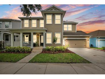 Beautiful two-story home featuring a covered porch, well-manicured lawn, and a two-car garage at 5949 Parkset Dr, Lithia, FL 33547