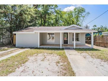 Charming single-story home featuring a welcoming porch and neutral exterior paint at 805 E Elm St, Tampa, FL 33604