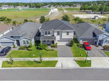 Beautiful two-story home with a well-manicured lawn, paver driveway and sidewalk in a desirable neighborhood at 10814 Whitland Grove Dr, Riverview, FL 33578